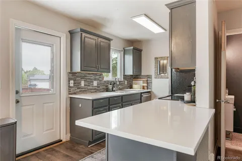 a kitchen with a stove a sink and a refrigerator