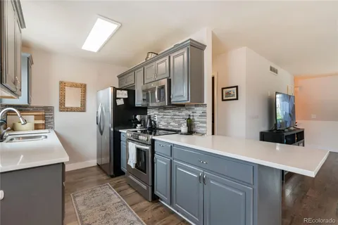 a kitchen with a sink stove and refrigerator