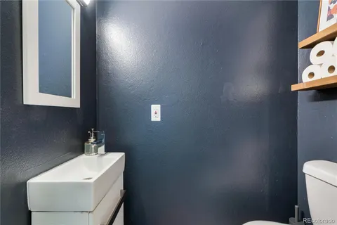 a bathroom with a sink a toilet and mirror