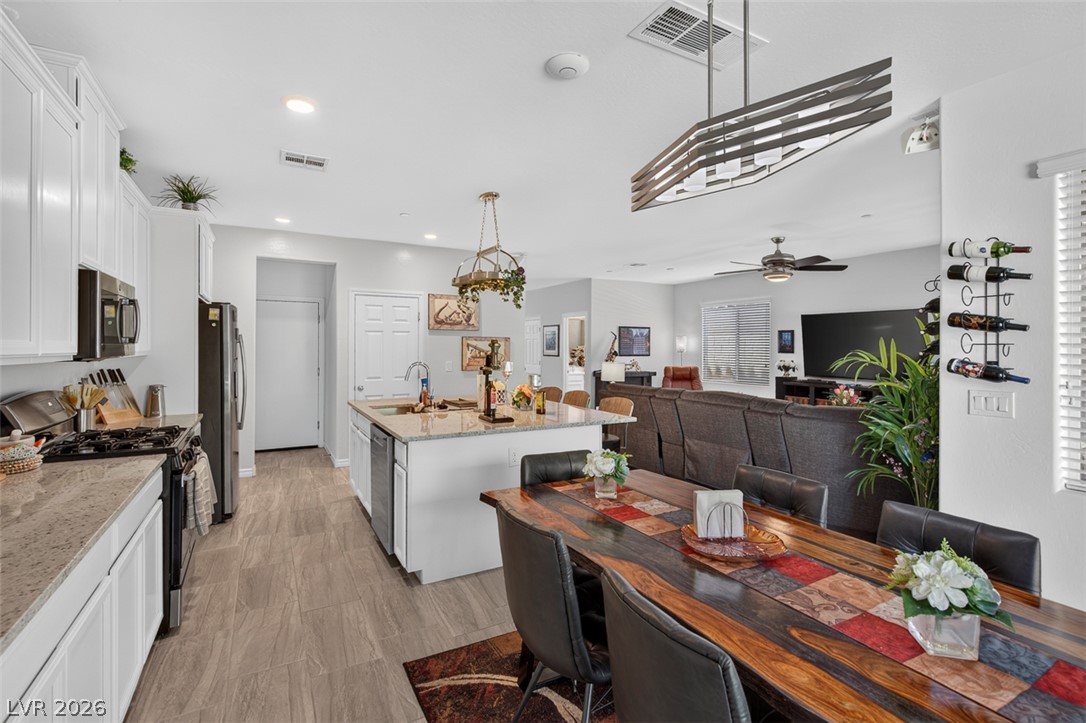 1824 Redland Ridge Street Henderson, NV 89002 - Photo 14 of 69 An open concept design seamlessly connects the kitchen with the dining and living areas, perfect for entertaining.
