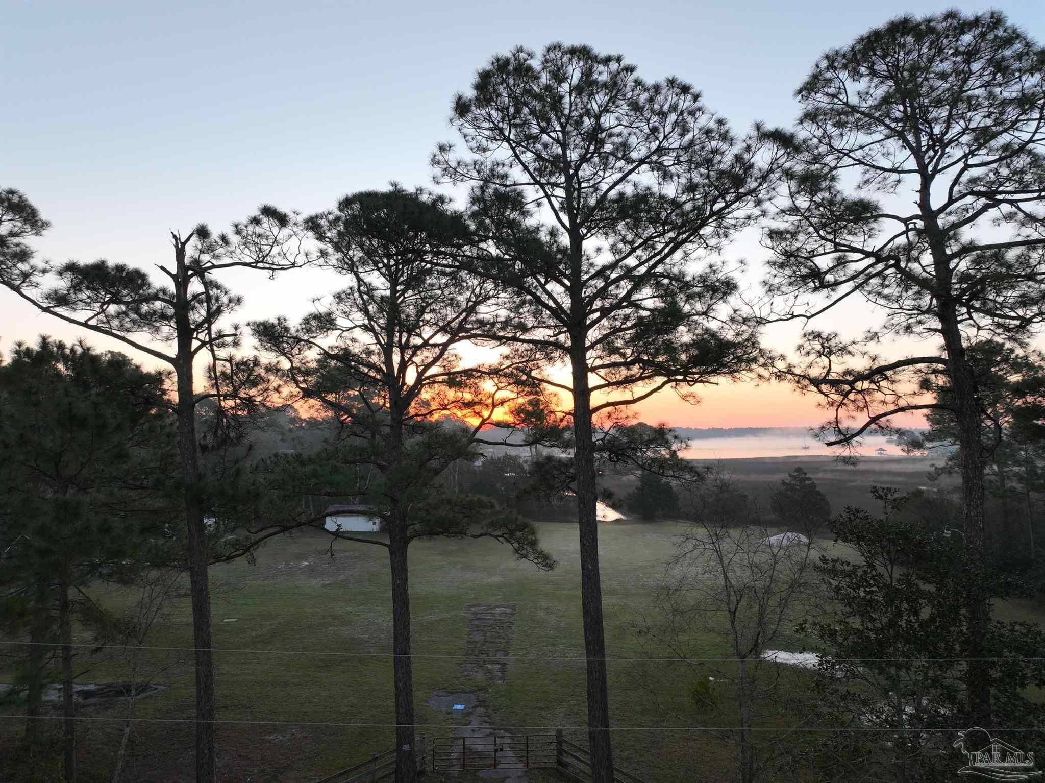 7524 Petersen Point Road Milton, FL 32583 - Photo 23 of 26 a backyard of a house with lots of green space