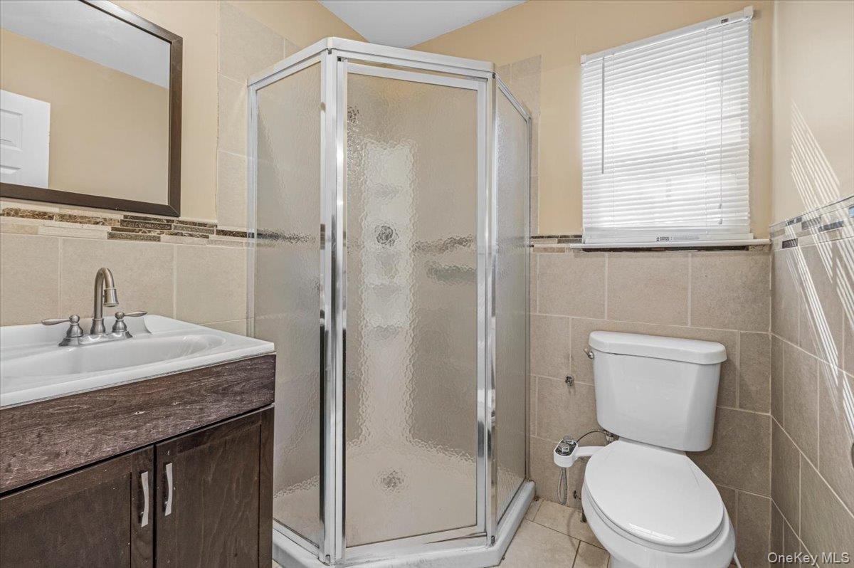 626 Caledonia Road Dix Hills, NY 11746 - Photo 22 of 49 a bathroom with a granite countertop toilet sink and shower
