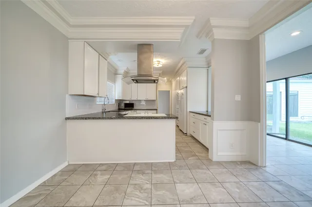 a view of kitchen with granite countertop cabinets and white appliances