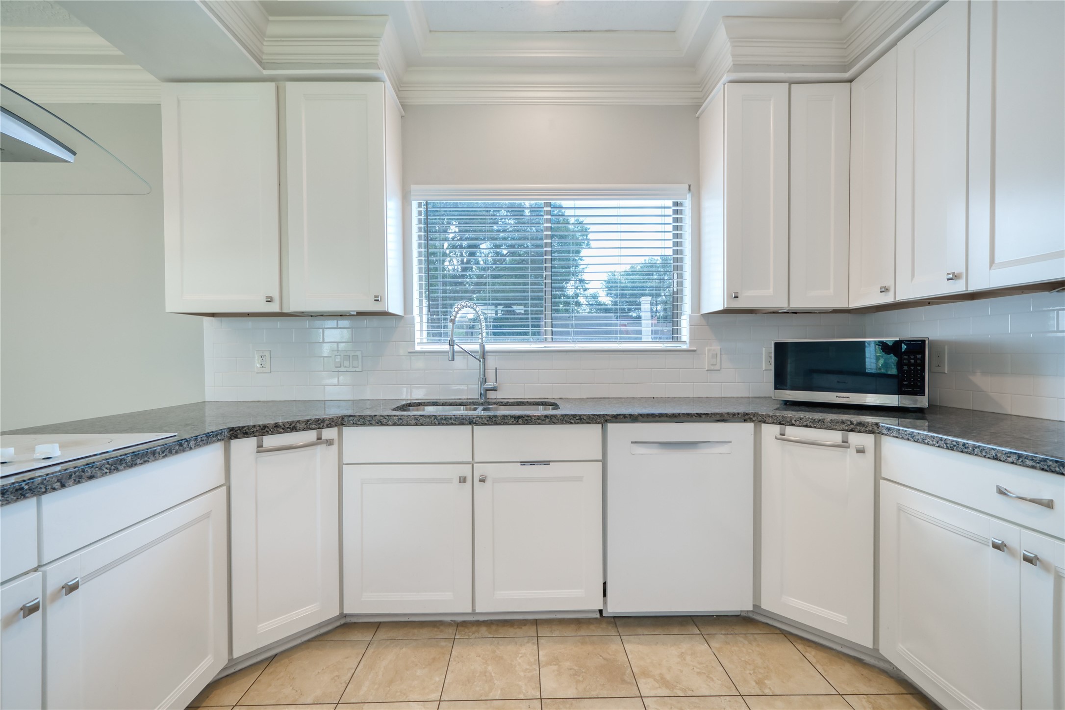10919 Villa Lea Lane Houston, TX 77071 - Photo 18 of 45 a kitchen with cabinets appliances a sink and a window
