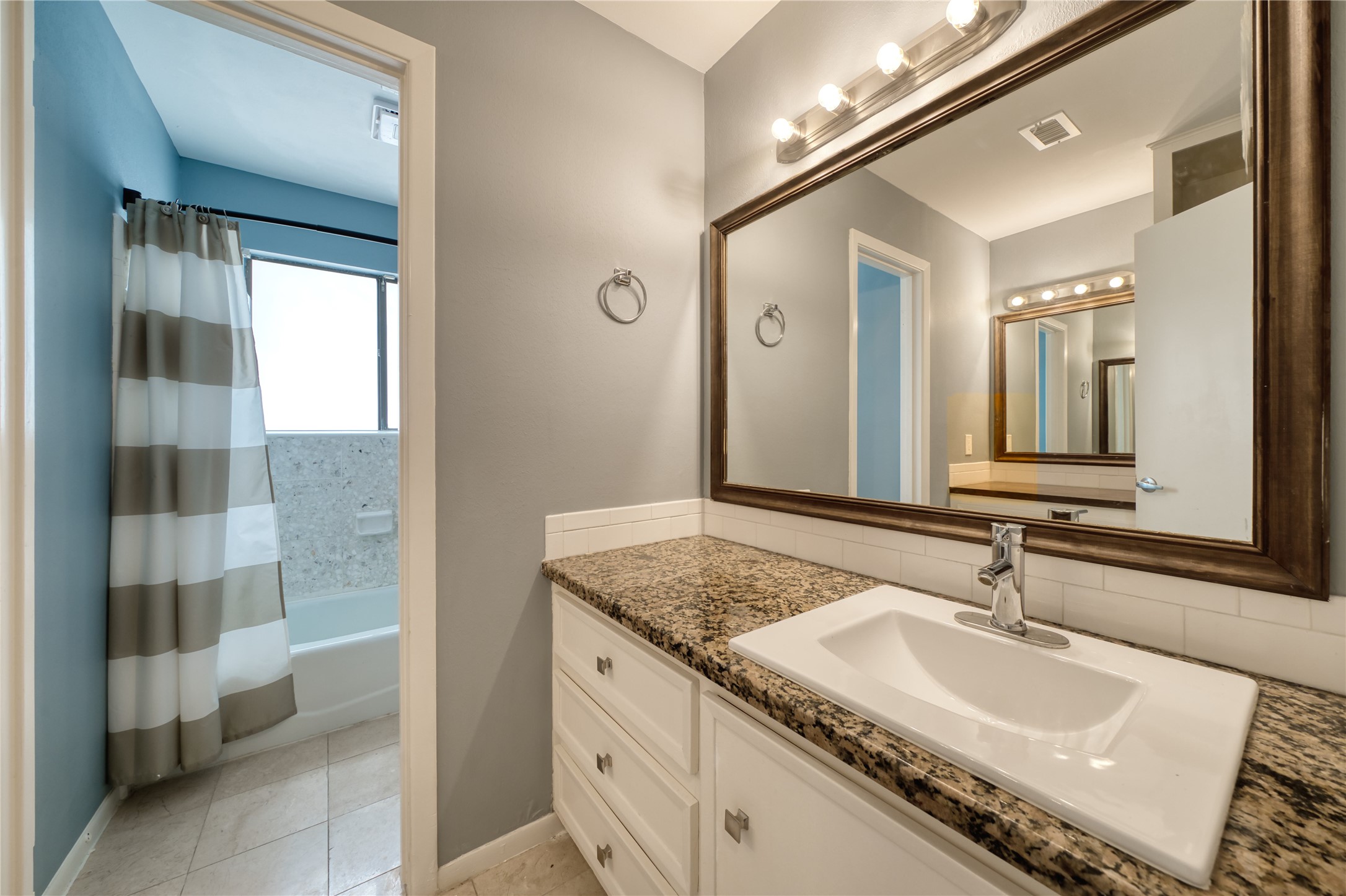 10919 Villa Lea Lane Houston, TX 77071 - Photo 23 of 45 a bathroom with a granite countertop sink and a mirror