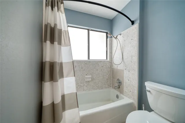 a bathroom with a toilet and a bathtub