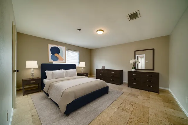 a bedroom with a bed and a dresser