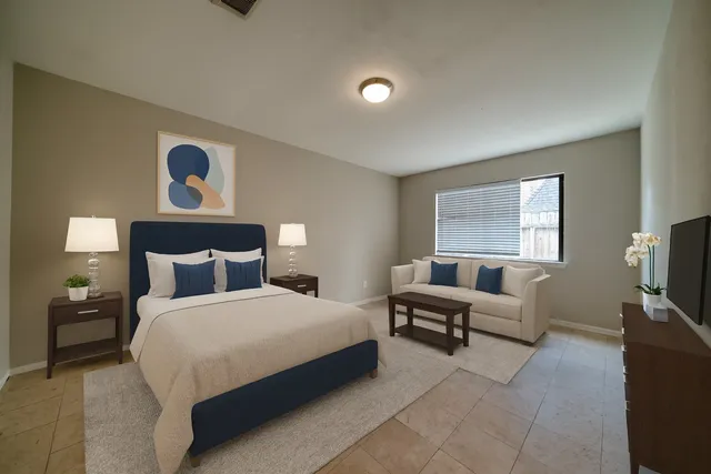 a bedroom with a bed and a couch