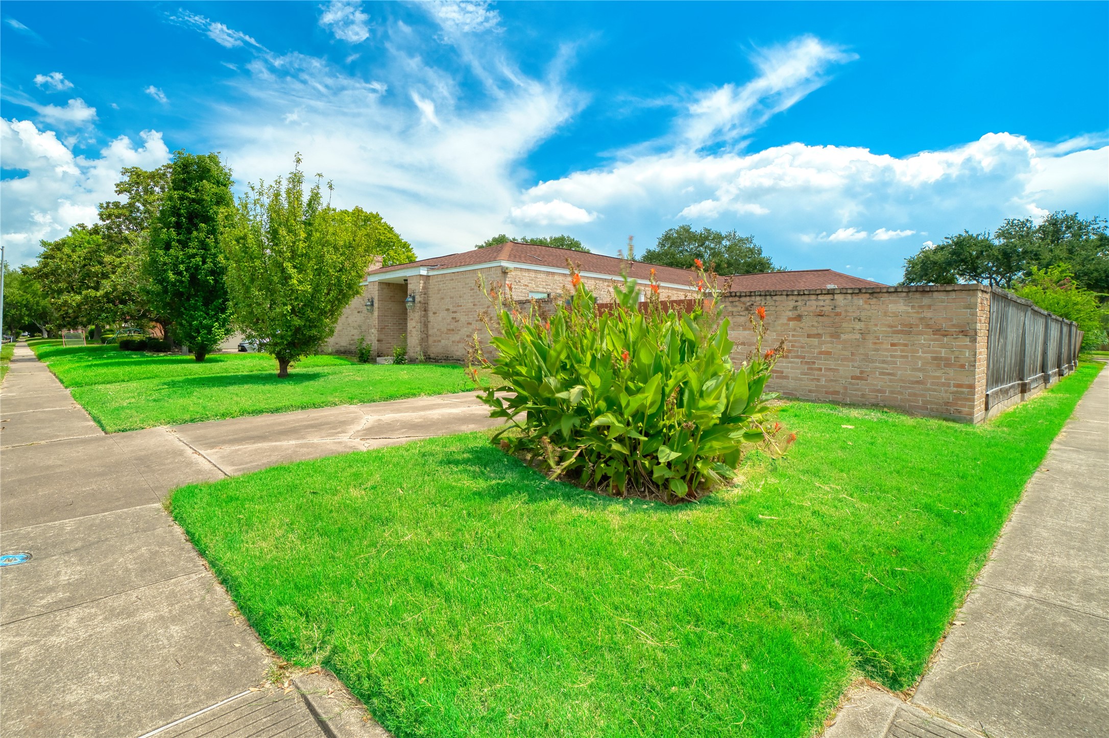 10919 Villa Lea Lane Houston, TX 77071 - Photo 3 of 45 a view of a garden with a building in the background