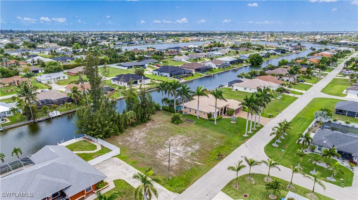 1318 Southwest 4th Avenue Cape Coral, FL 33991 - Photo 11 of 16 an aerial view of a house with a lake view