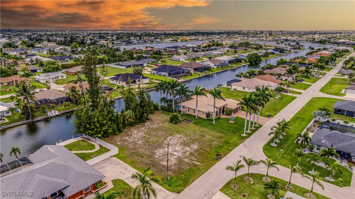 1318 Southwest 4th Avenue Cape Coral, FL 33991 - Photo 12 of 16 an aerial view of a house with a lake view