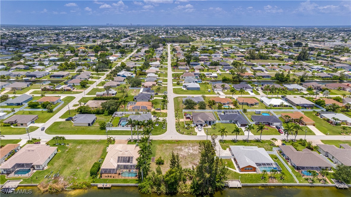 1318 Southwest 4th Avenue Cape Coral, FL 33991 - Photo 3 of 16 an aerial view of residential houses with outdoor space and trees