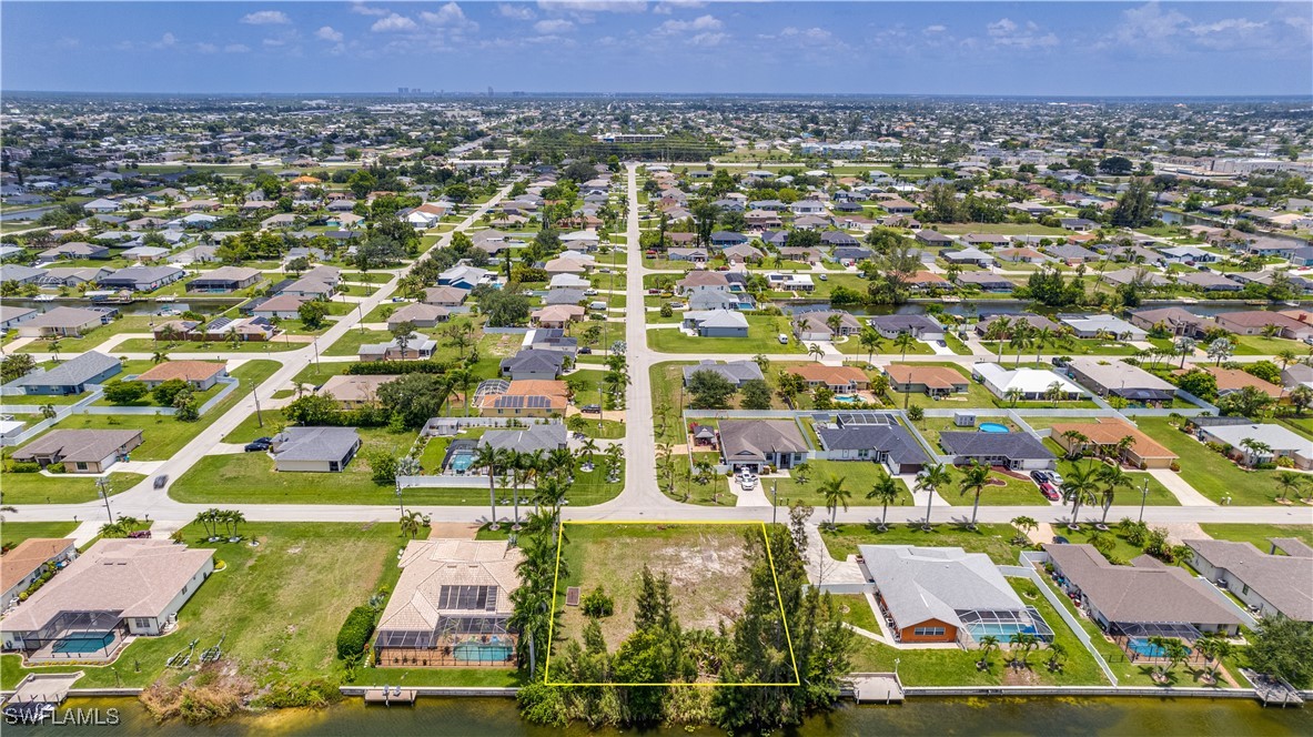 1318 Southwest 4th Avenue Cape Coral, FL 33991 - Photo 4 of 16 an aerial view of residential houses with outdoor space