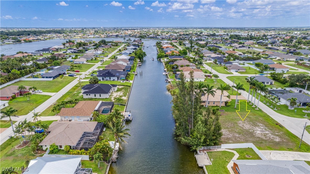 1318 Southwest 4th Avenue Cape Coral, FL 33991 - Photo 10 of 16 an aerial view of residential houses with outdoor space and lake view