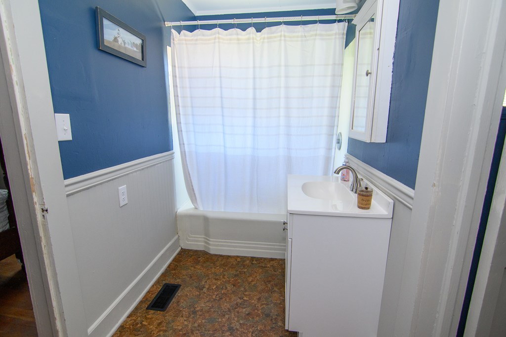 24432 Maxwell Street Parksley, VA 23421 - Photo 18 of 39 a bathroom with a window and a shower