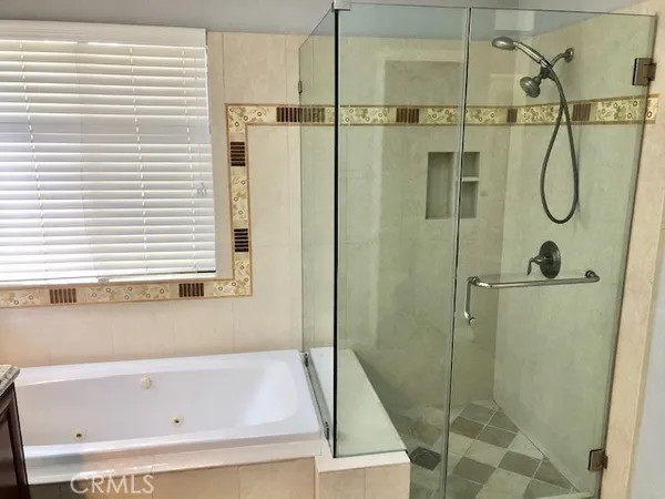 a bathroom with a shower and a tub