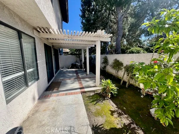 a view of a patio with table and chairs potted plants