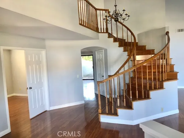 a view of entryway with wooden floor and stairs