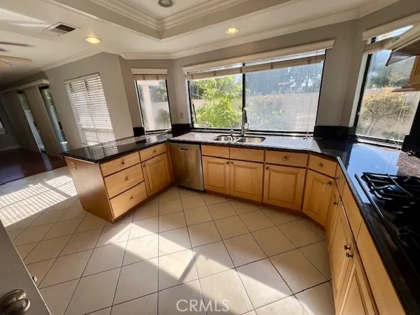 a kitchen with stainless steel appliances granite countertop a sink and stove