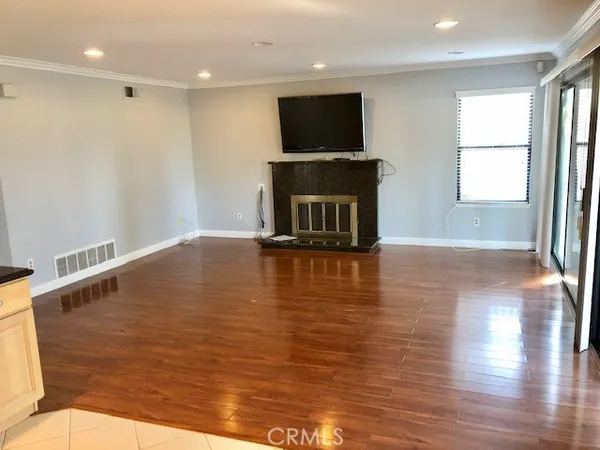 a view of a livingroom with furniture flat screen tv and window