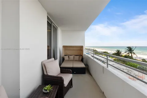 a view of roof deck with couple of chairs