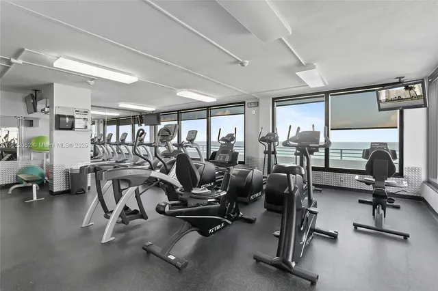 a view of a tall building next to a yard