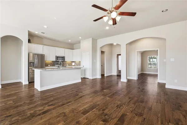 a view of a livingroom with wooden floor and a fireplace