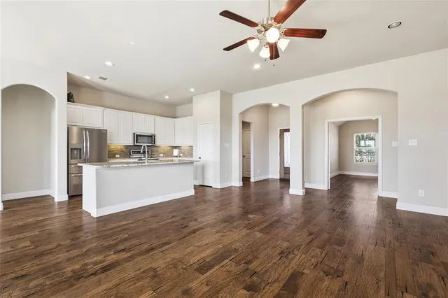 a view of a livingroom with wooden floor and a fireplace