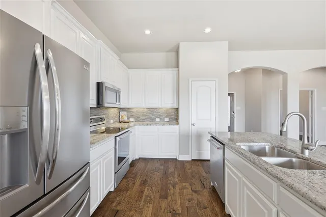 a view of a kitchen with a sink dishwasher and a fireplace