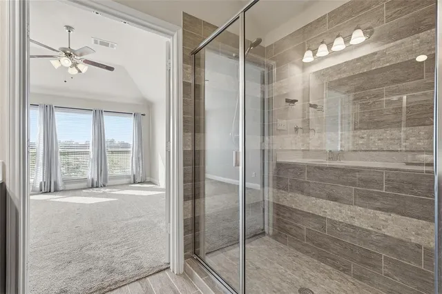 a bathroom with a double vanity sink mirror and shower
