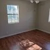a view of a small space with wooden floor and a window