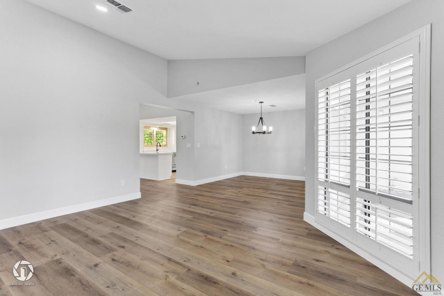 Undisclosed Address Bakersfield, CA 93308 - Photo 11 of 48 a view of an empty room with wooden floor and a window