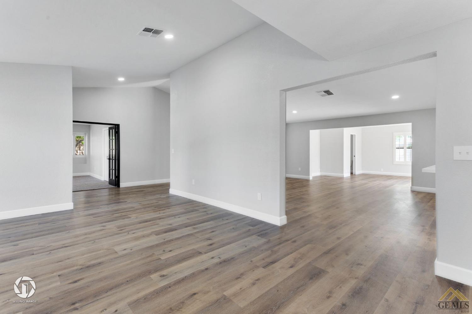 Undisclosed Address Bakersfield, CA 93308 - Photo 13 of 48 a view of an empty room with wooden floor and a window