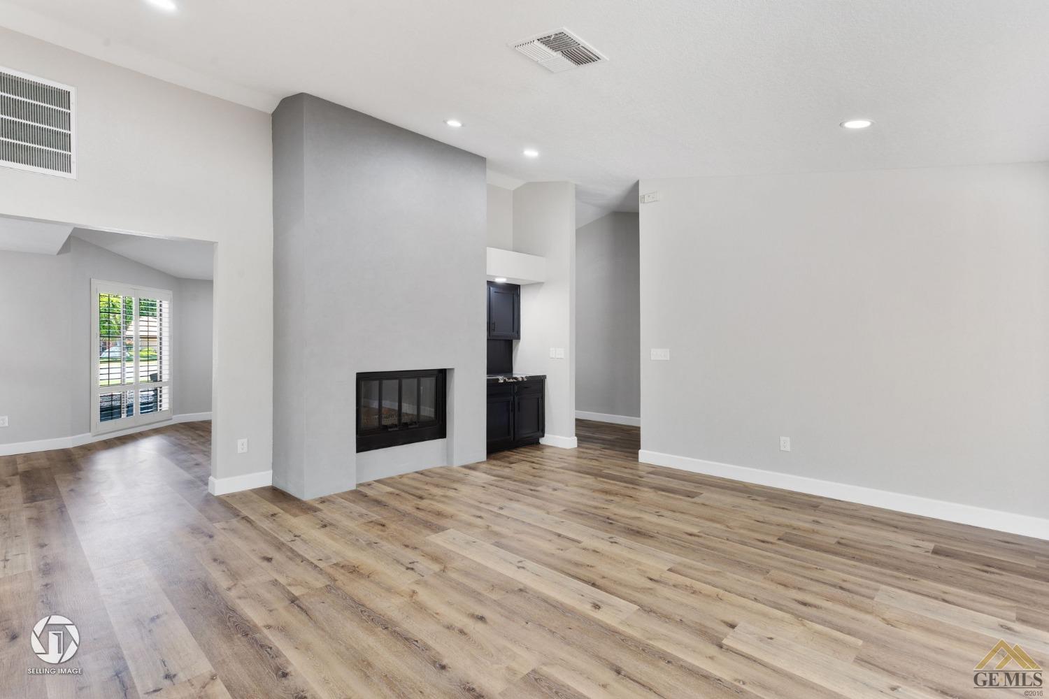 Undisclosed Address Bakersfield, CA 93308 - Photo 15 of 48 an empty room with wooden floor and windows