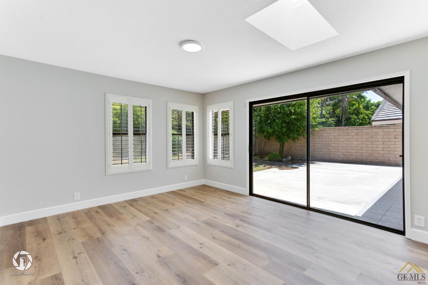 Undisclosed Address Bakersfield, CA 93308 - Photo 18 of 48 a view of an empty room with wooden floor and glass door