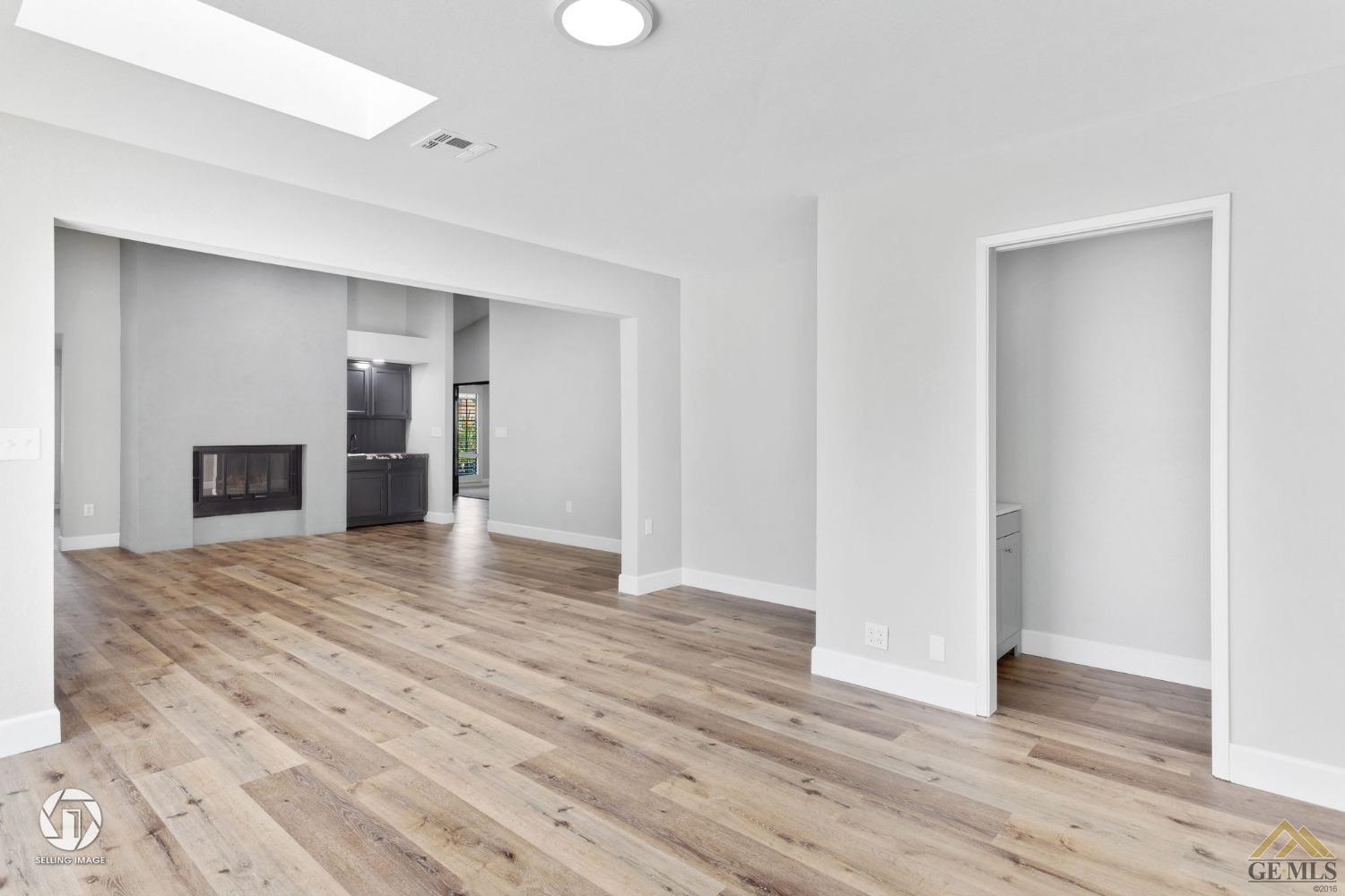 Undisclosed Address Bakersfield, CA 93308 - Photo 19 of 48 a view of an empty room with wooden floor and a window