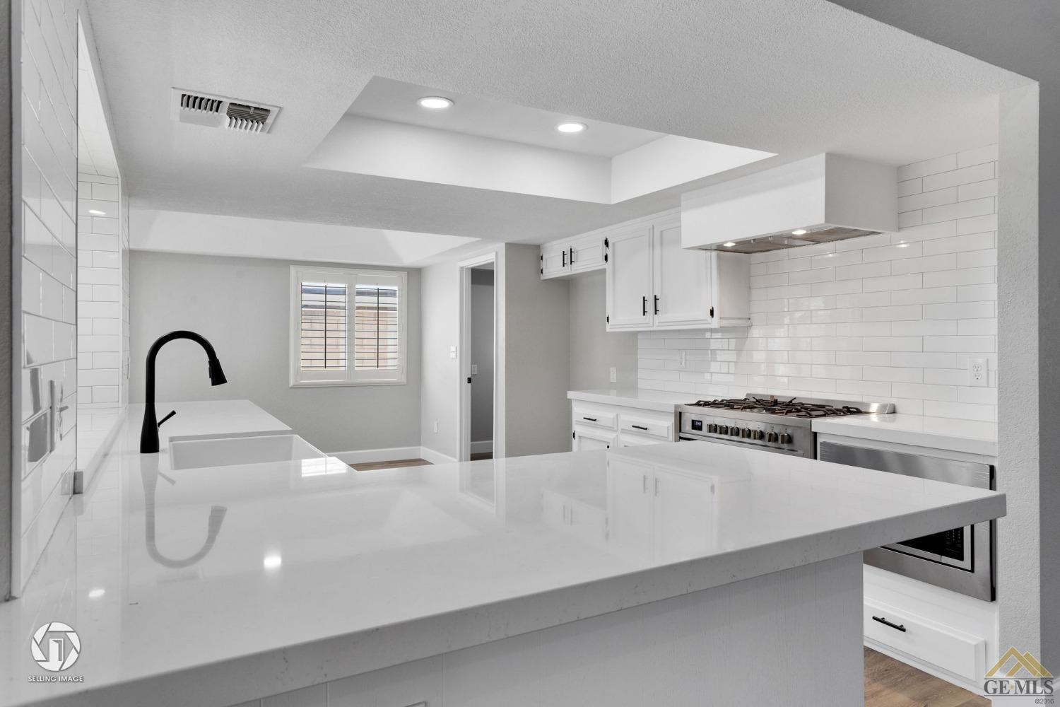 Undisclosed Address Bakersfield, CA 93308 - Photo 21 of 48 a kitchen with kitchen island a sink stainless steel appliances and cabinets