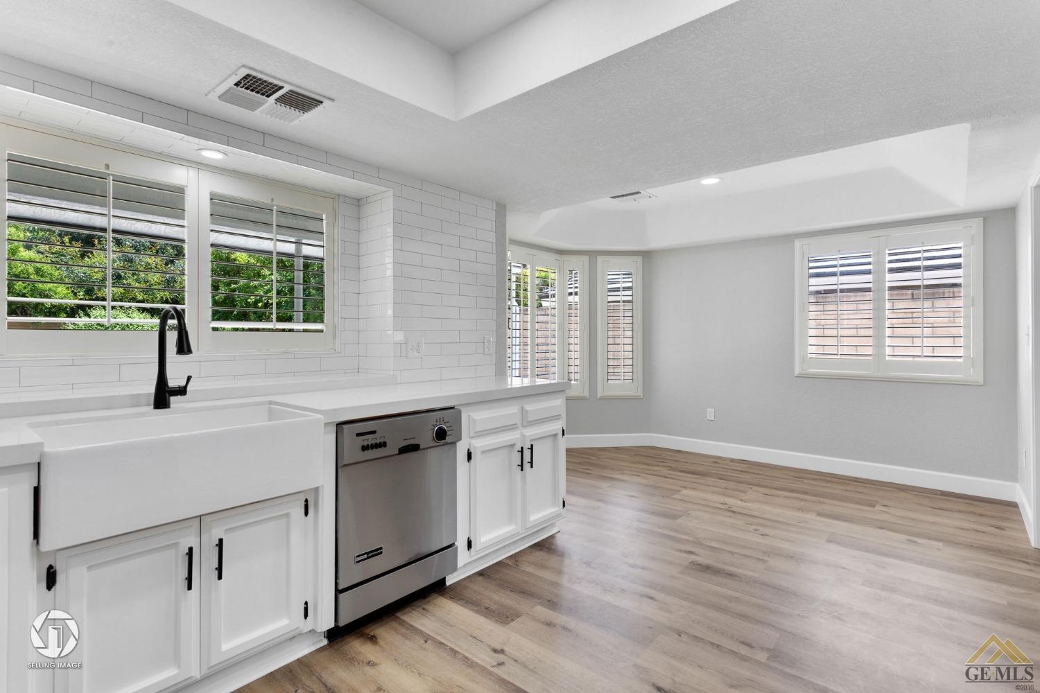 Undisclosed Address Bakersfield, CA 93308 - Photo 23 of 48 a kitchen with granite countertop white cabinets and a large window