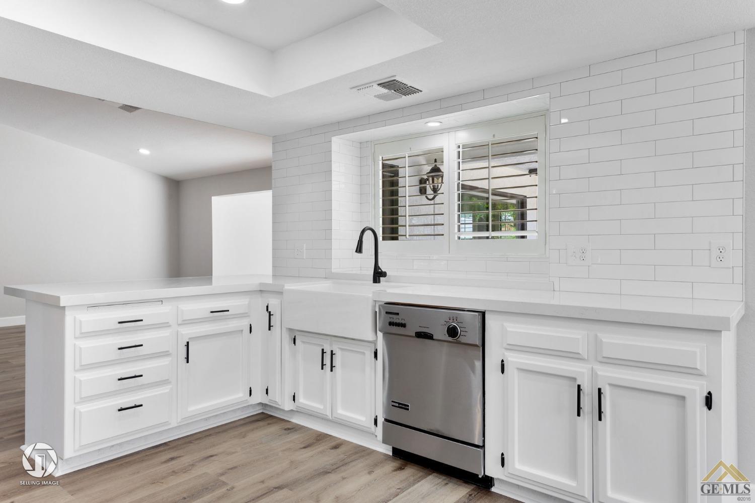 Undisclosed Address Bakersfield, CA 93308 - Photo 25 of 48 a view of cabinets a wooden floor windows and a sink