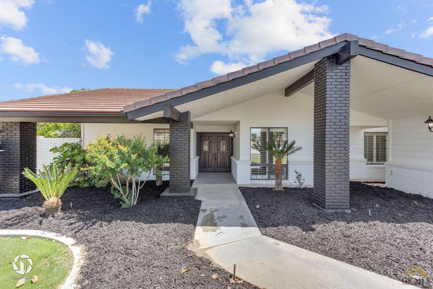 Undisclosed Address Bakersfield, CA 93308 - Photo 3 of 48 a front view of a house with garden