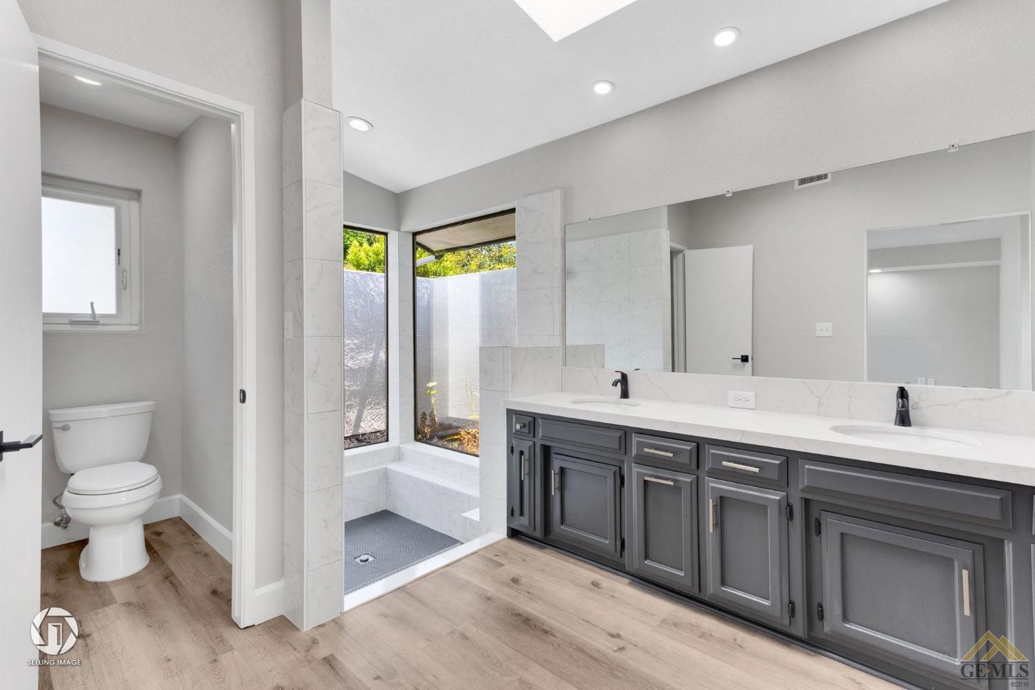 Undisclosed Address Bakersfield, CA 93308 - Photo 33 of 48 a bathroom with a double vanity sink toilet and shower