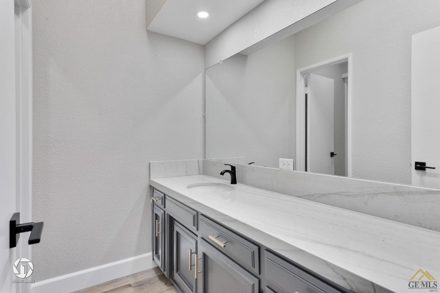 Undisclosed Address Bakersfield, CA 93308 - Photo 39 of 48 a bathroom with a sink and a mirror