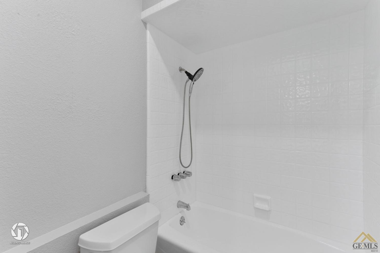 Undisclosed Address Bakersfield, CA 93308 - Photo 40 of 48 a bathroom with a granite countertop toilet and a tub