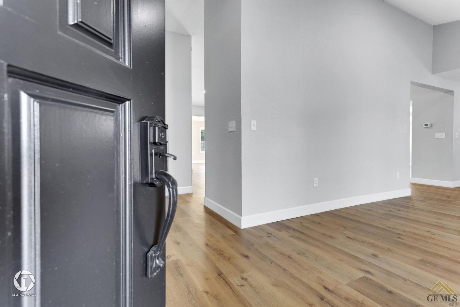 Undisclosed Address Bakersfield, CA 93308 - Photo 4 of 48 a view of a hallway with wooden floor