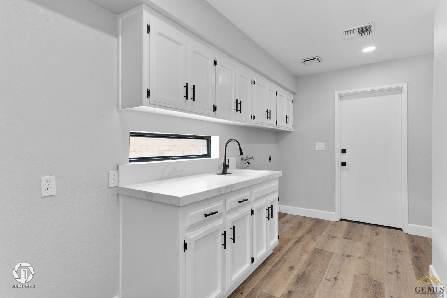 Undisclosed Address Bakersfield, CA 93308 - Photo 43 of 48 a kitchen with cabinets a sink and dishwasher