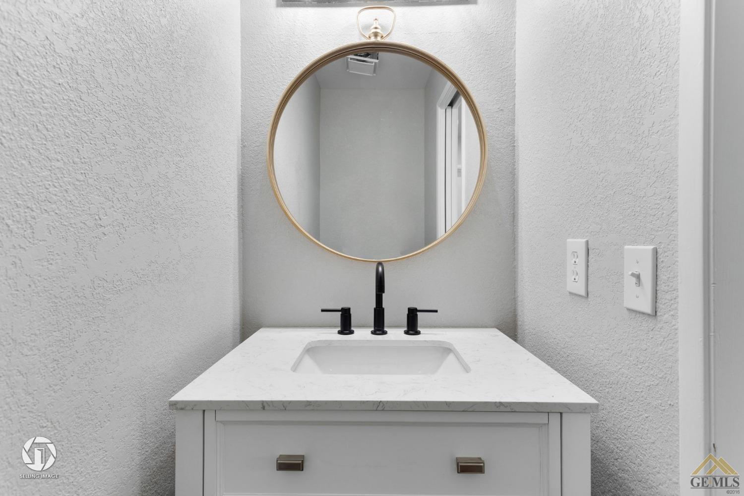 Undisclosed Address Bakersfield, CA 93308 - Photo 44 of 48 a bathroom with a sink and a mirror