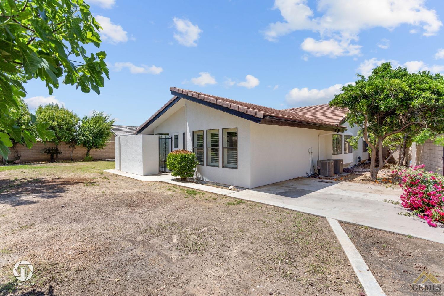 Undisclosed Address Bakersfield, CA 93308 - Photo 48 of 48 a front view of a house with a garden
