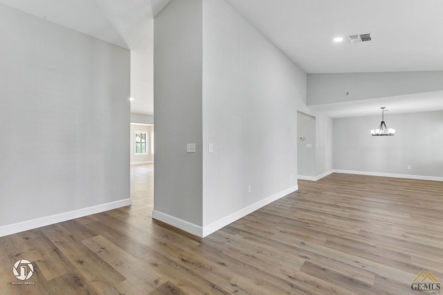 Undisclosed Address Bakersfield, CA 93308 - Photo 6 of 48 an empty room with wooden floor and windows