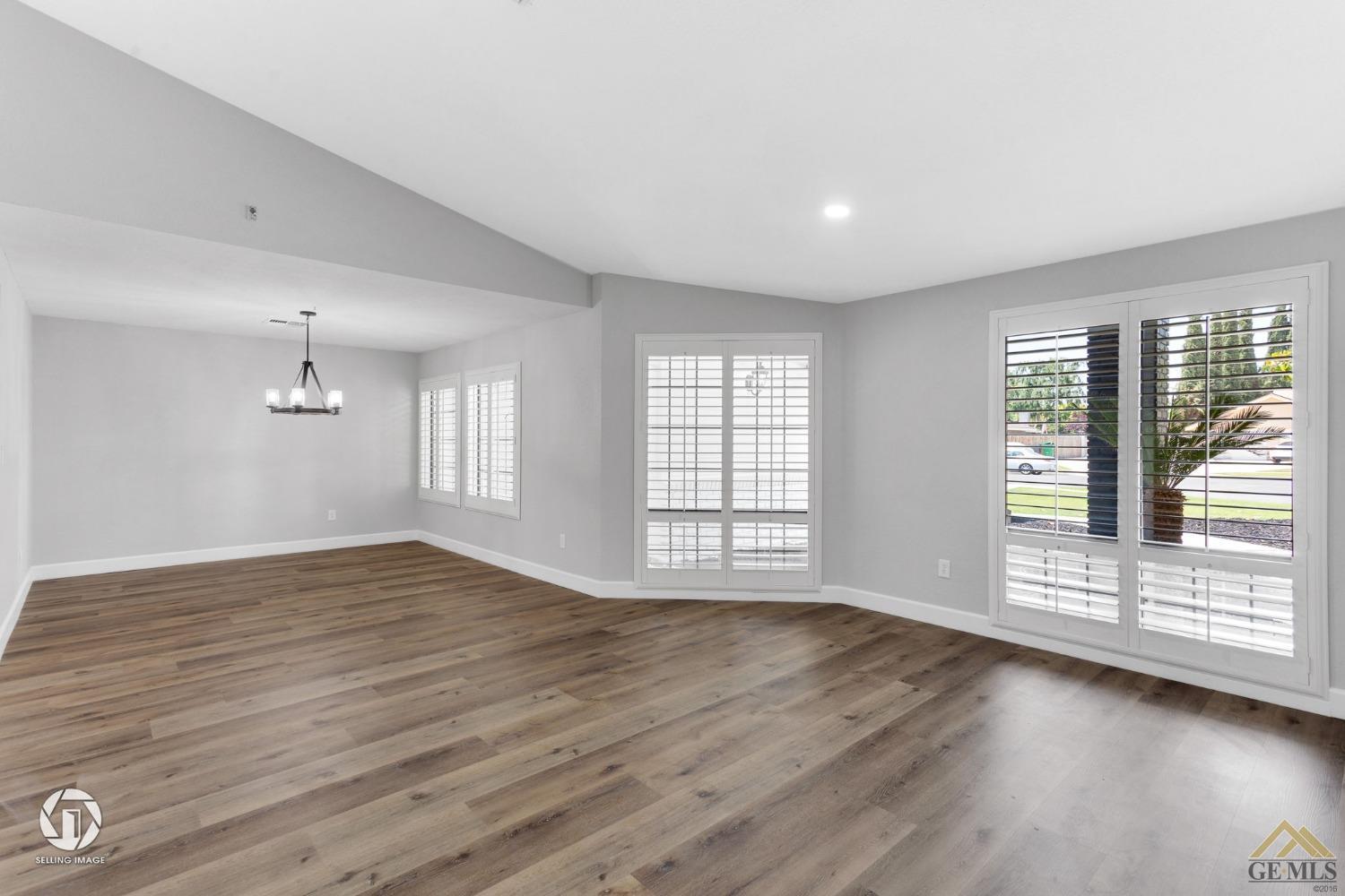 Undisclosed Address Bakersfield, CA 93308 - Photo 7 of 48 a view of an empty room with wooden floor and a window