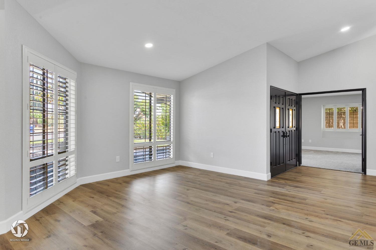 Undisclosed Address Bakersfield, CA 93308 - Photo 10 of 48 a view of an empty room with wooden floor and a window
